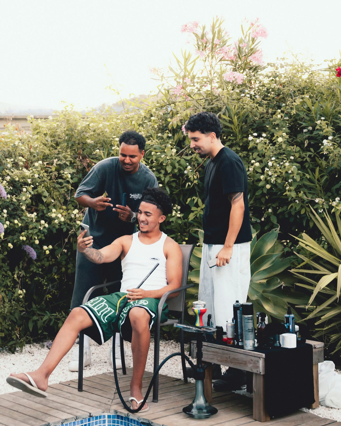 Barbers and a client talking in the chair before the cut at The Cave